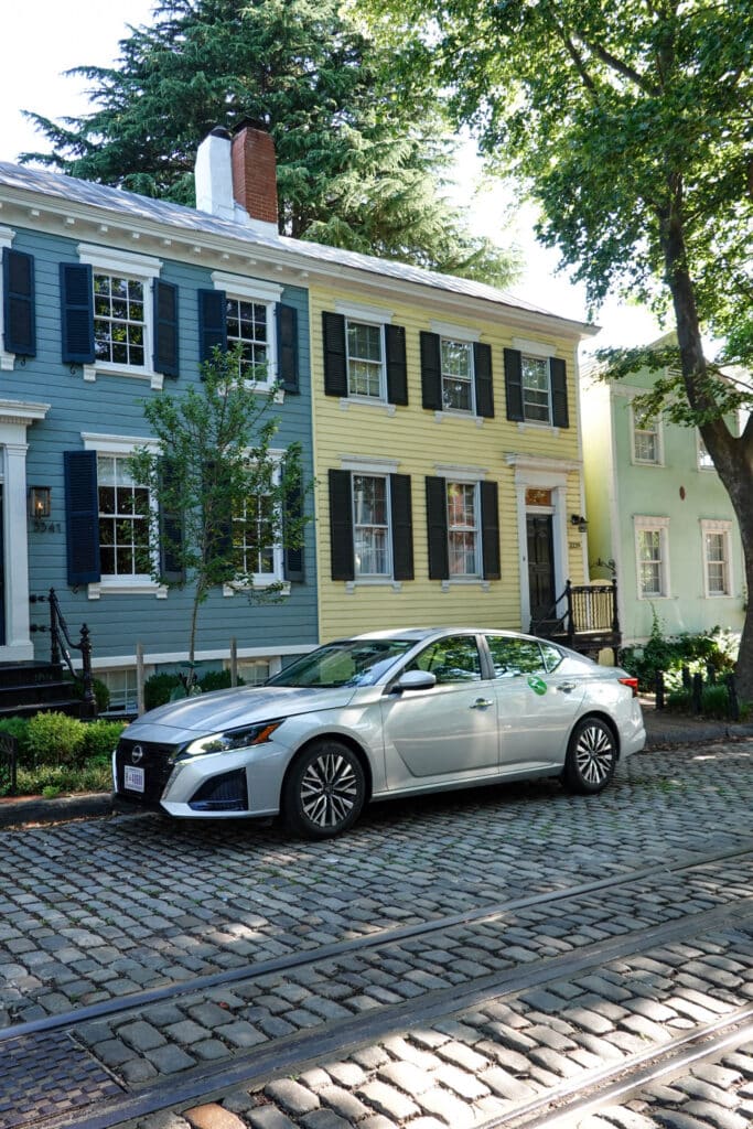 Zipcar parked on a cobblestone street